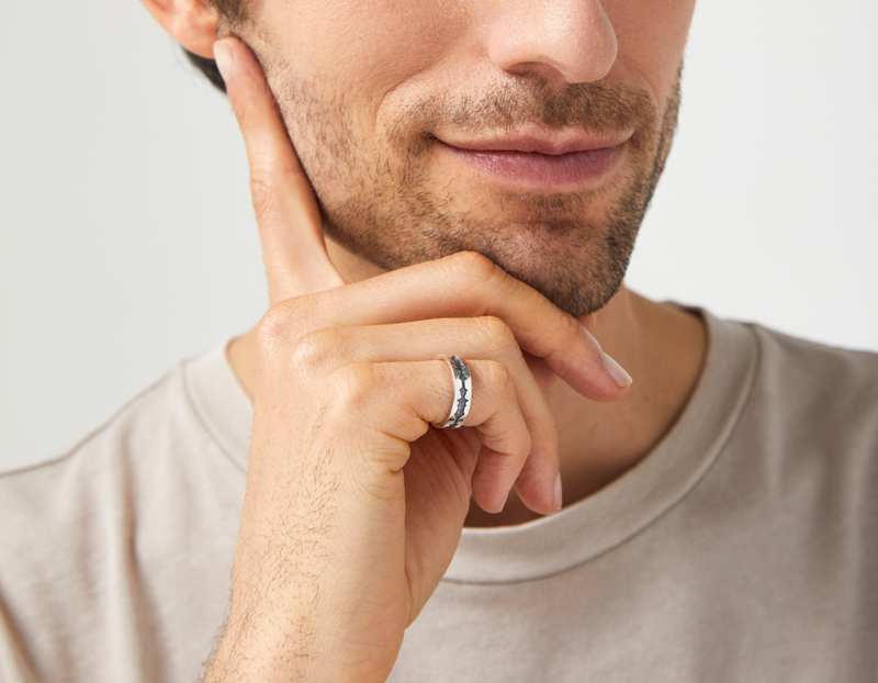 The Outer Wave Ring in Antiqued Sterling Silver on a male