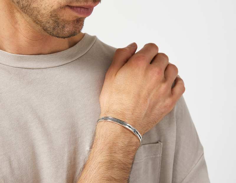 The Outer Wave Bracelet in Antiqued Sterling Silver on a male