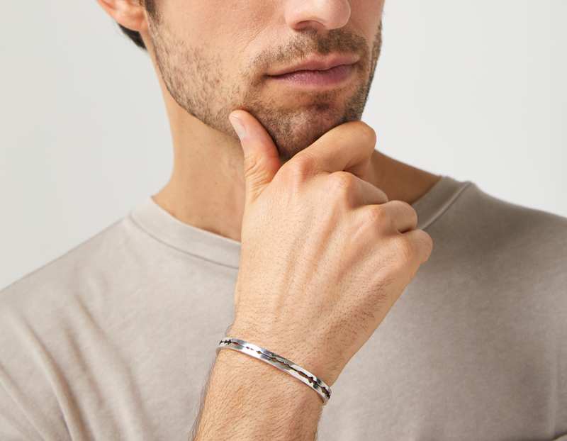 The Cut Wave Bracelet in Antiqued Sterling Silver on a male