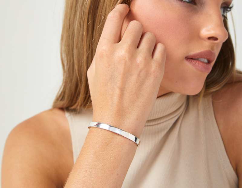 The Inner Wave Bracelet in Sterling Silver on a female