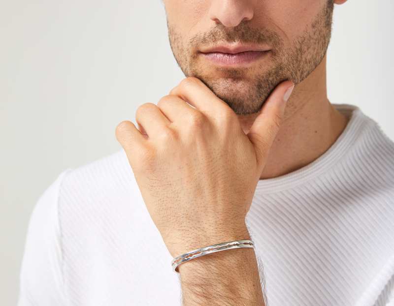 The Cut Wave Bracelet in Sterling Silver on a male