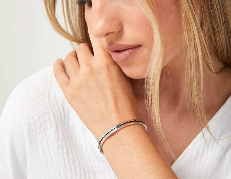 The Cut Wave Bracelet in Antiqued Sterling Silver on a female