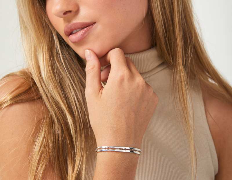 The Cut Wave Bracelet in Sterling Silver on a female