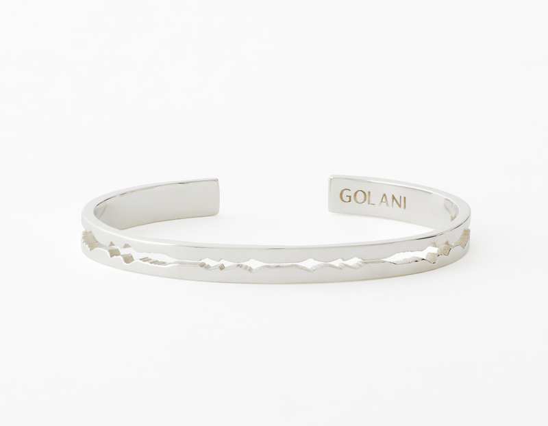 The Cut Wave Bracelet placed horizontal in Sterling Silver