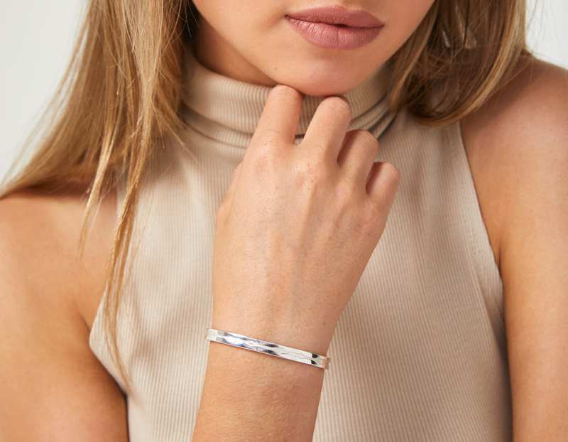 The Outer Wave Bracelet in Sterling Silver on a female
