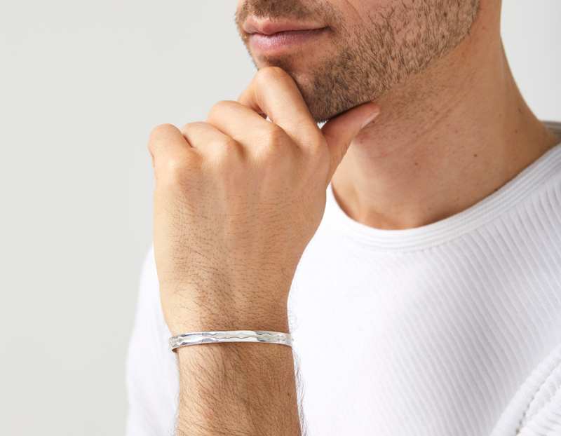 The Outer Wave Bracelet in Sterling Silver on a male