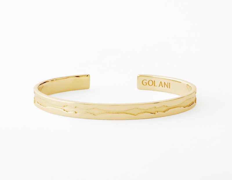 The Outer Wave Bracelet placed horizontal in 14-Karat Gold